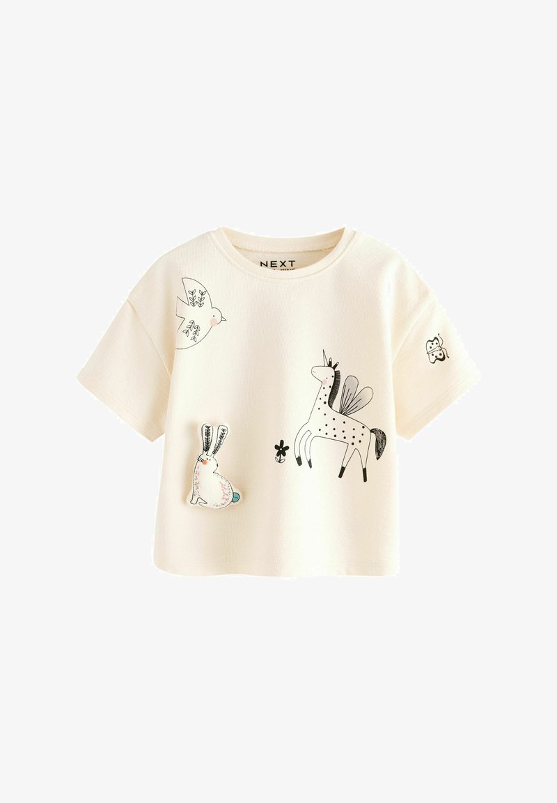 T-shirt pour enfants couleur crème avec des illustrations d'animaux en noir et blanc, comprenant un lapin, une licorne, un oiseau et un papillon.