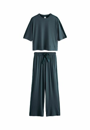 Dunkelblaues, kurzärmeliges, cropped T-Shirt, kombiniert mit weiten Hosen, die über einen elastischen Bund und eine vordere Bindedetail verfügen. Glatte Textur.