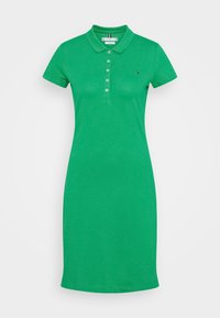 Vihreä poolopaita, joka on valmistettu puuvillasekoitteesta. Siinä on kauluspääntie, lyhyet hihat, napitus ja logo-tyyli rintapelkällä.