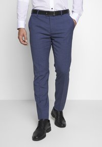 Tailored dress pants in blue with a subtle check pattern, featuring a flat front, side pockets, and a black belt, paired with black shoes.