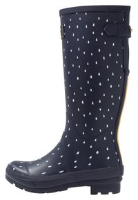 Botte de pluie en caoutchouc bleu marine avec un motif de gouttes de pluie blanches, sangle réglable près du haut et bande jaune à l'arrière.