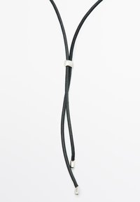 Black leather cord necklace with two strands and a silver metal clasp. Ends feature small metal tips. Simple, minimalist design.