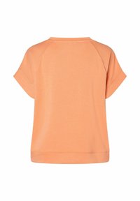 Perzikkleurig t-shirt met korte mouwen en een ronde halslijn. Heeft raglanmouwen en een rechte zoom. Zachte textuur met een ontspannen pasvorm.