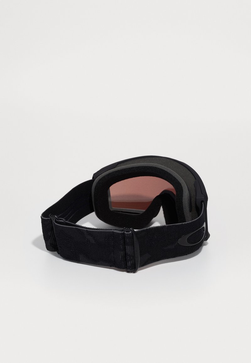 Lunettes de ski noires avec un cadre rembourré et une sangle réglable. La lentille a une teinte rosée. Elle dispose d'une sangle texturée pour un meilleur maintien et un confort optimal.
