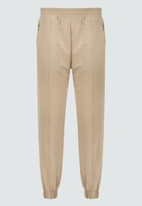 Beige joggers met een elastische tailleband, ritszakken en elastische manchetten bij de enkels. Glad stofoppervlak met een stijlvolle pasvorm.