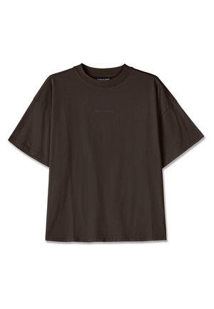 Dark brown, oversized cotton t-shirt featuring short sleeves and a round neckline. Front has subtle "PEGADOR" logo in matching tone.