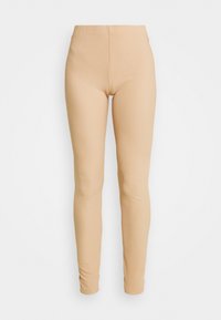 Beige leggingit, jotka on valmistettu joustavasta kankaasta, joissa on sileä pinta, istuva muotoilu ja korkea vyötärö mukavuutta varten.