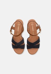 Brown leather sandals with a black suede front design and ankle strap. Features a smooth insole with "Marco Tozzi" branding. Size 37.