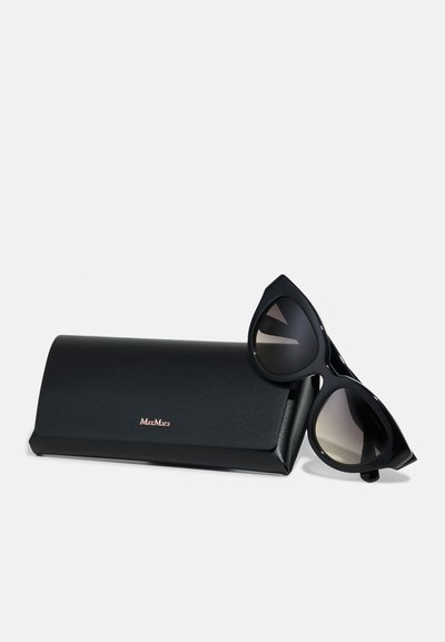 Black sunglasses with a unique cat-eye shape, featuring gradient lenses. Includes a black carrying case with "MaxMara" logo in rose gold.