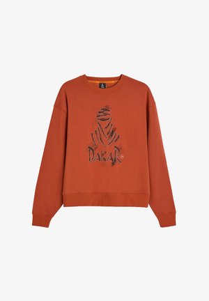 Pomarańczowy sweatshirt wykonany z mieszanki bawełny, z dużym czarnym logo graficznym na środku oraz ściągaczami na mankietach i u dołu.