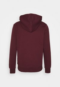Burgundy hoodie med snörning i huvan, långa ärmar och ribbade mudd. Mjuk tyg med en slät yta och en avslappnad passform.