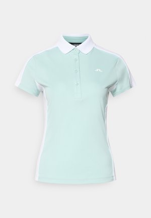 Hellmintgrünes Poloshirt mit weißem Kragen, ausgestattet mit einer Dreiknopfleiste und kontrastierenden Seitenpaneelen. Logo auf der Brust.