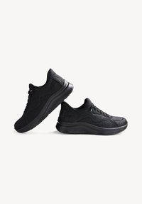Black athletic shoes with textured knit upper, rounded toe, cushioned sole, and lace-up closure. Subtle design accents in black.