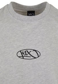 Grå bomulls t-skjorte med rund hals og korte ermer; har et svart ovalt logo sentrert på brystet. Myk tekstur og uformell design.