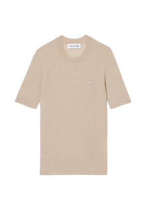 Suéter de punto corto beige con cuello redondo y logo de Lacoste bordado en el pecho izquierdo.