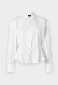 White peplum shirt with long sleeves, classic collar, and front button closure. Made from smooth cotton fabric with a structured design.