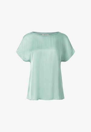 Blusa di seta verde menta chiaro con una vestibilità ampia, maniche corte e scollo rotondo. Texture liscia con dettagli di cucitura minimi.