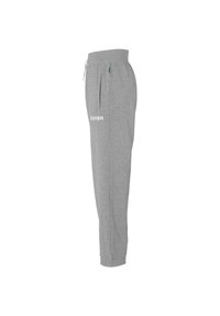 Grijze sweatpants gemaakt van zachte stof, met een koord in de taille, zijzakken en een wit "Kempa" logo op de linker dij.