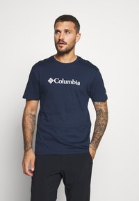 Navy blue cotton t-shirt featuring the white Columbia logo on the chest. Short sleeves and a round neckline.