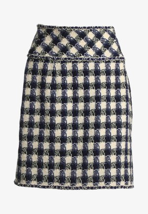 Mini-jupe en laine avec une taille haute, présentant un motif à carreaux bleu, noir et blanc et une bordure décorative le long de la taille et de l'ourlet.