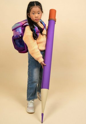 Riesenlila Bleistift mit orangespitze, gehalten von einem Kind, das einen kuscheligen creamfarbenen Pullover und blaue Jeans trägt, mit einem lila Rucksack.
