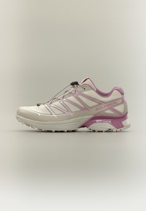 Lightweight running shoe in cream and pink, featuring a breathable mesh upper, synthetic accents, elastic lacing system, and textured sole.