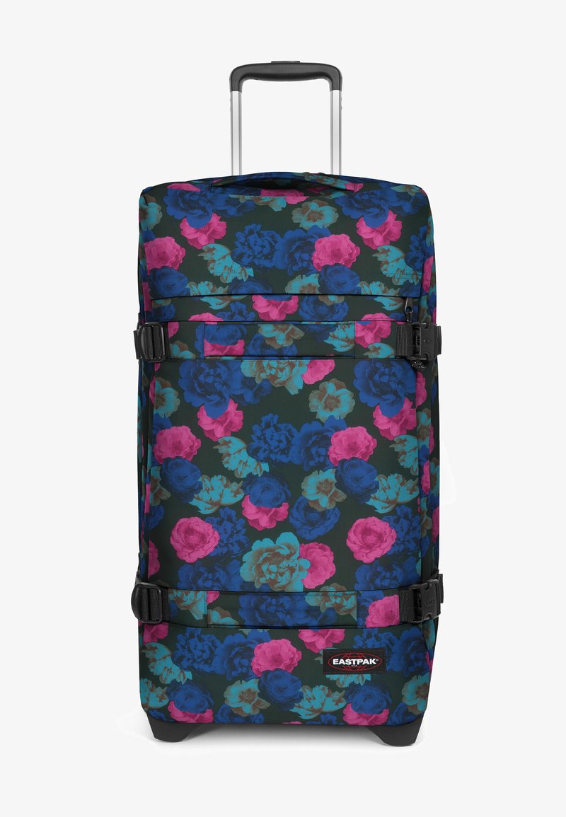 Svart resväska med blommönster i blått, rosa och grönt. Har två justerbara remmar, en logopatch och ett utdragbart handtag.
