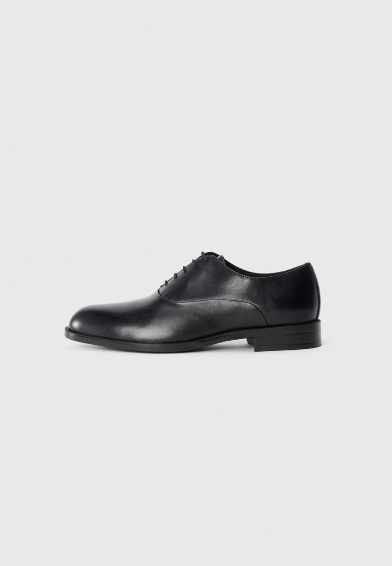 Black leather men's dress shoe with closed lacing, rounded toe, low heel, and a smooth polished finish on a white background.