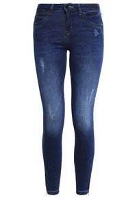 Vaqueros ajustados de mezclilla en azul oscuro con desvanecidos claros, detalles desgastados, cierre de botón y cremalleras en los tobillos para un estilo y comodidad adicionales.