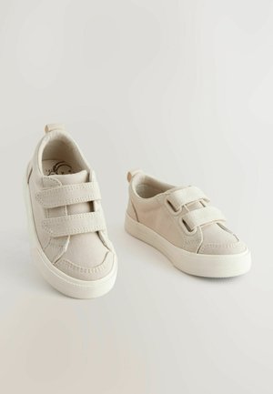 Beige kangastossud kahekordsete Velcro rihmadega, ümmarguse ninaga ja kummist tallaga. Omab tikandiga disaini ja sildiga kannaosas.