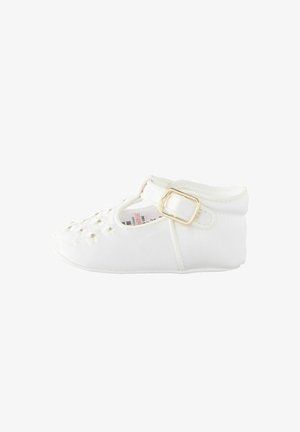 White textile shoe with a T-strap and gold buckle, featuring small embroidered daisies on the toe and a soft, padded collar.