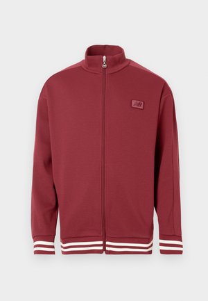Red zip-up jacket with a stand collar, striped white accents on sleeves, soft material, and a small logo patch on the chest.