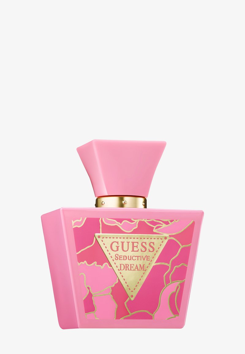Pink trapezoid Guess Seductive Dream perfume bottle with gold floral accents and a wide pink cap.