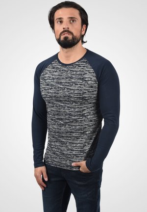 Long-sleeve T-shirt featuring a textured gray and navy design with contrasting raglan sleeves, made of soft, stretchy fabric.