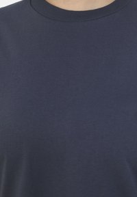 Navy blue cotton t-shirt featuring a round neckline and smooth texture, with minimal seams and a classic fit design.