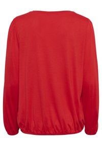 Punainen pitkähiha-paita, valmistettu pehmeästä kankaasta, pyöreällä pääntiellä. Tässä paidassa on kerätyt hihansuut ja kiristetty helma. Sileä pinta, rento istuvuus.