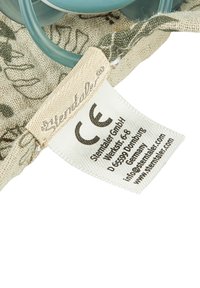 Cotton fabric pouch with floral pattern, featuring blue plastic handles and a care label with CE mark. Textured surface and natural colors.