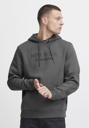 Gray hoodie with drawstrings, front kangaroo pocket, and black printed text "NEW YORK BLIND DENIM" on the chest. Soft, textured fabric.
