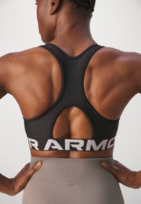 Under Armour MID BRANDED - Medium support sports bra - black/white
