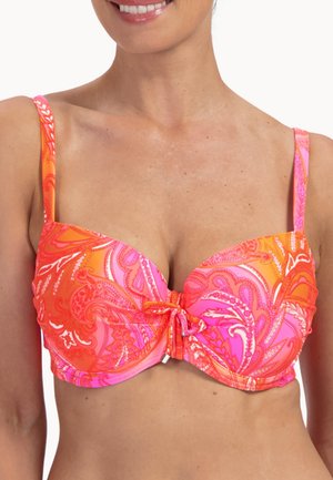 Frau trägt ein lebhaftes Bikinioberteil mit Paisley-Muster in Pink und Orange, verstellbaren Trägern und einer vorne gebundenen Schnur.