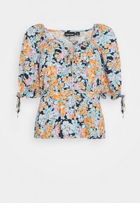 Blusa floral com uma base azul-marinho, apresentando flores vibrantes em laranja e em tons pastéis. Mangas bufantes, laços ajustáveis nos pulsos e uma cintura franzida.