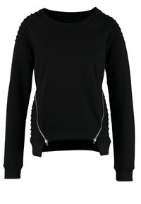 Sweat-shirt noir à manches longues avec des détails côtelés horizontaux sur les épaules et les côtés, présentant deux fermetures éclair argentées diagonales à l'avant.