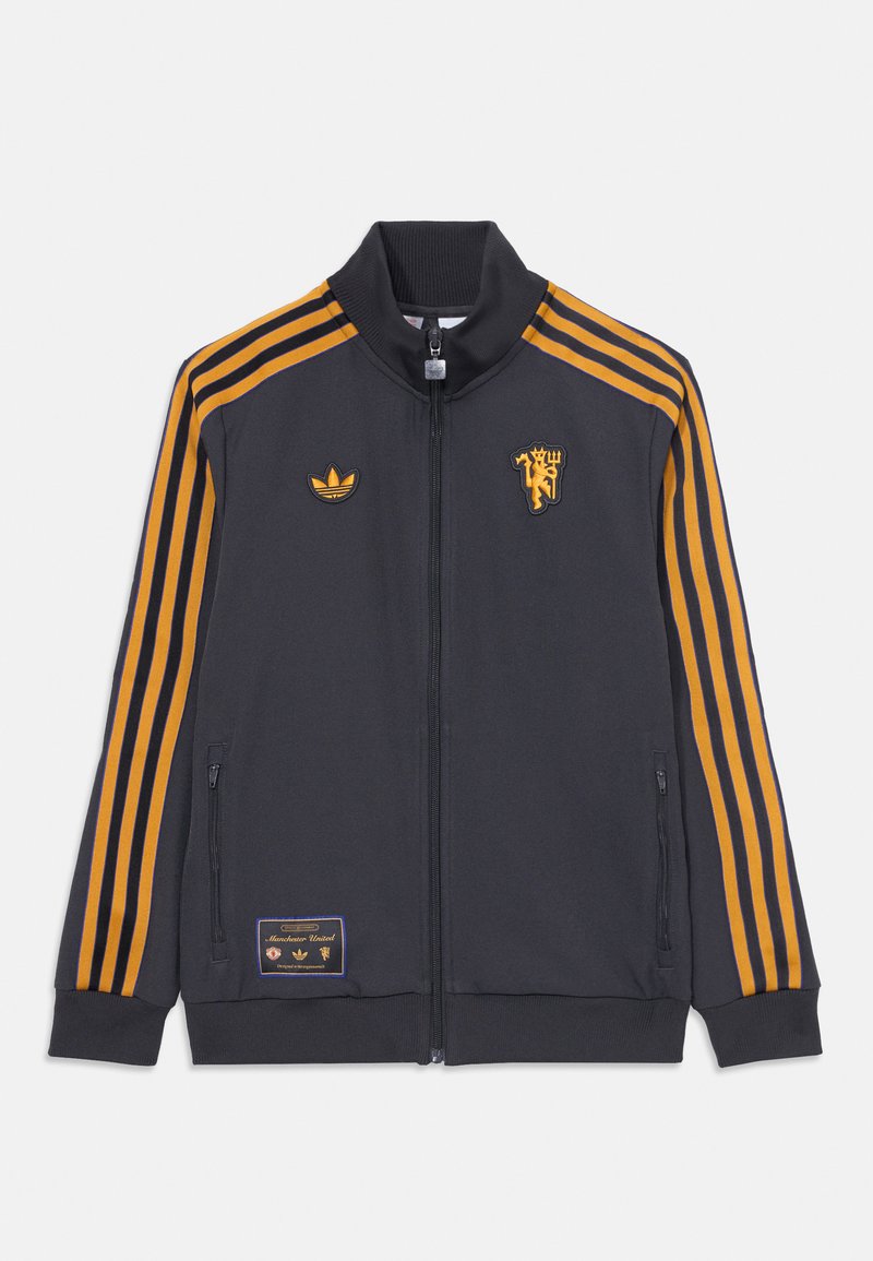 Mörkgrå zip-up jacka med gulorange ränder, ribbad krage och mudd. Har broderade logotyper och en tygpatch på den nedre framsidan.