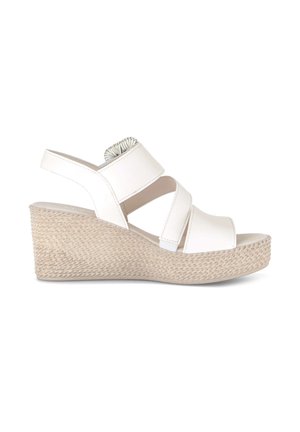 White wedge sandal with woven platform sole and three wide straps, including one around the ankle with elastic detail.