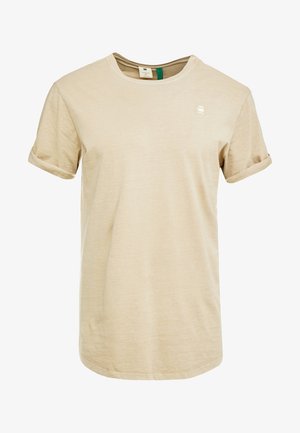 Beiges T-Shirt mit kurzem Ärmel und Rundhalsausschnitt, mit aufgerollten Bündchen und kleinem weißem Logo auf der linken Brust.