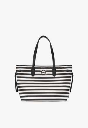 Csíkos vászontáska, fekete és fehér színben, tartós anyagból készült, fekete fogantyúkkal, kiemelt logóval és oldalsó húzózsinór díszítéssel.