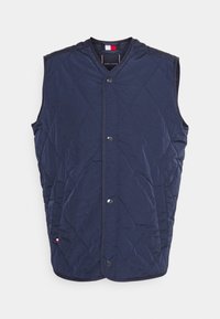 Marineblau gesteppte Weste mit Knopfverschluss, ärmellosem Design und Rautenmuster. Verfügt über einen runden Ausschnitt und kontrastierende Fütterung.