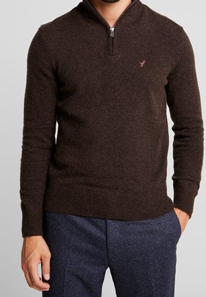 Brauner Zip-Kragen-Pullover mit gerippten Bündchen und Saum, aus strukturiertem Strickstoff, mit einer kleinen Logo-Stickerei auf der Brust.
