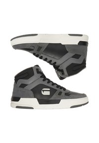 Musta ja halli nahast ning sametist kõrged tossud, millel on polsterdatud krae, tekstureeritud külgpaneelid ja kindel valge kummist tall.