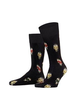 Zwarte sokken met een herhaald notenkrakermotief in rood, geel en groen. Gemaakt met een gladde textuur en een geribde boord voor comfort.